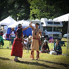Two people joining hands at the powwow