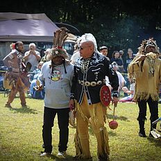 Two men talking at the powwow