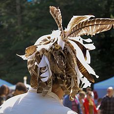 People wearing feathers at powwow