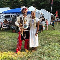 Two people enjoying the powwow